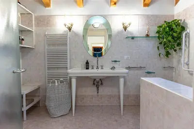 a bathroom with a sink and a mirror at La Villa del Barone in Predaia