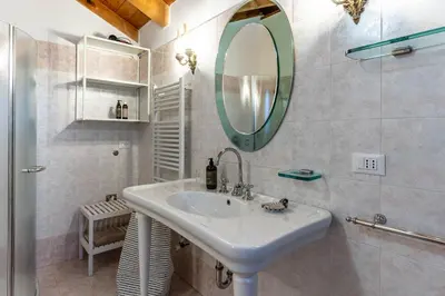 a bathroom with a sink and a mirror at La Villa del Barone in Predaia