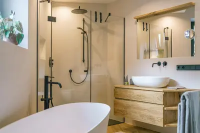 a bathroom with a tub and a sink and a shower at Auszait Apartments 2 in Caldaro