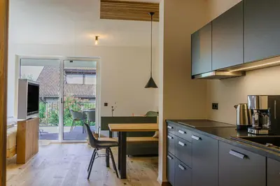 a kitchen with a table and a dining room at Auszait Apartments 2 in Caldaro