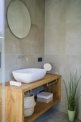 a bathroom with a white sink and a mirror at Auszait Apartments 2 in Caldaro