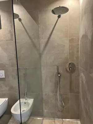 a bathroom with a shower with a toilet and a sink at Auszait Apartments 1 in Caldaro