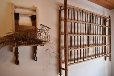 a room with a wooden cage and a mirror at romy's B&B in Braies