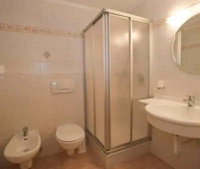 a bathroom with a shower and a toilet and a sink at romy's B&B in Braies