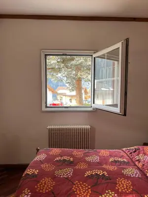 a bedroom with a bed and a window at Gardena SudTirol Gianni's Home in Santa Cristina in Val Gardena