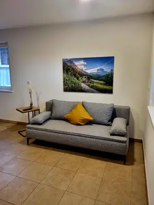 a couch in a living room with a painting on the wall at Gartnerhof in Plaus