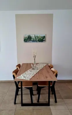 a wooden table with chairs and a vase on it at Gartnerhof in Plaus