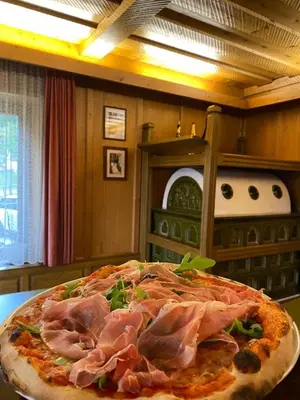 a pizza sitting on top of a table at Albergo Scoiattolo in Tret