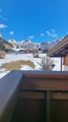 a view of a snow covered field from a deck at B&B Ciauceia in Selva di Val Gardena