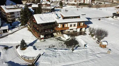 an aerial view of a house in the snow at B&B Ciauceia in Selva di Val Gardena
