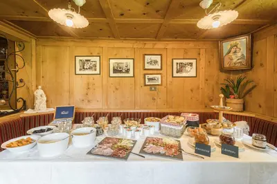 a table with food on it in a room at B&B Ciauceia in Selva di Val Gardena