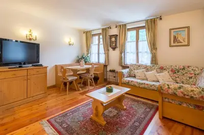 a living room with a couch and a table at Cozy apartment near Cortina in San Vito di Cadore