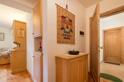 a hallway with a room with a door to a bedroom at Cozy apartment near Cortina in San Vito di Cadore