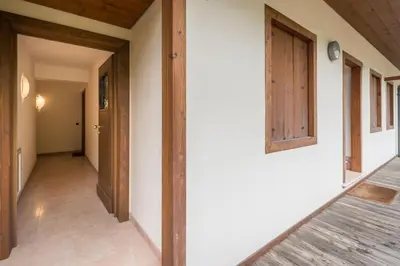 an empty hallway of a house with a door at Cozy apartment near Cortina in San Vito di Cadore