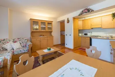 a living room with a couch and a table at Cozy apartment near Cortina in San Vito di Cadore