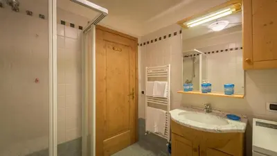a bathroom with a sink and a mirror at Cozy apartment near Cortina in San Vito di Cadore