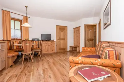 a living room with a couch and a table at Leishof in Villandro