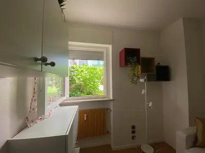 a kitchen with a window and a white counter top at Alloggio Dolomites in Bolzano