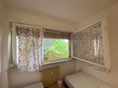 a small room with a window and a window seat at Alloggio Dolomites in Bolzano