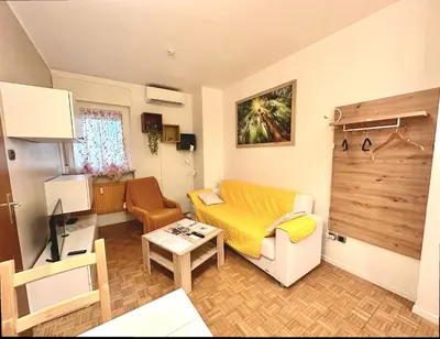a living room with a couch and a table at Alloggio Dolomites in Bolzano