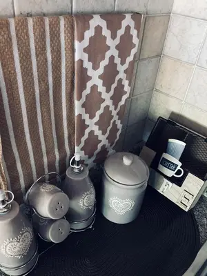 a group of vases sitting on a table in a bathroom at Appartamento El Feudo in Tesero