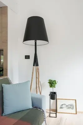 a living room with a blue couch and a black lamp at Villa Rames in Ortisei