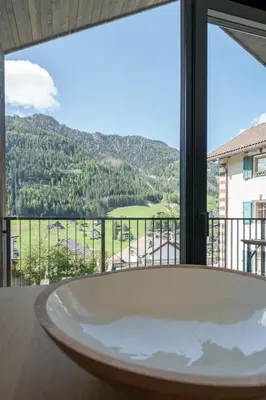 a bath tub in front of a window with a view at Villa Rames in Ortisei