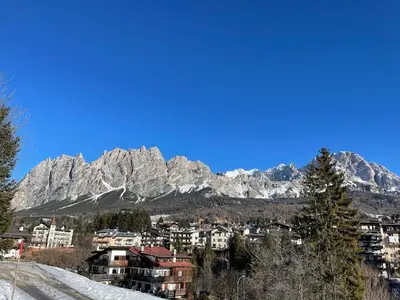 a view of a city with mountains in the background at Appartamento Crignes in Cortina dʼAmpezzo