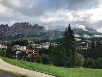 a view of a city with mountains in the background at Appartamento Crignes in Cortina dʼAmpezzo