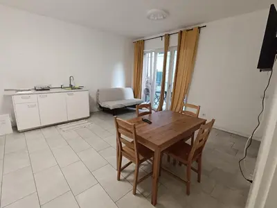 a kitchen and dining room with a table and chairs at Apartaments and Rooms Claudia Augusta in Bolzano