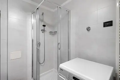 a white bathroom with a shower and a toilet at Casa Maria Beatrice in Mühlbach