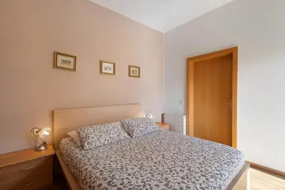 a bedroom with a bed and a wooden dresser at Casa Maria Beatrice in Mühlbach