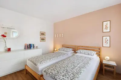 two beds in a small bedroom with a white wall at Casa Maria Beatrice in Mühlbach