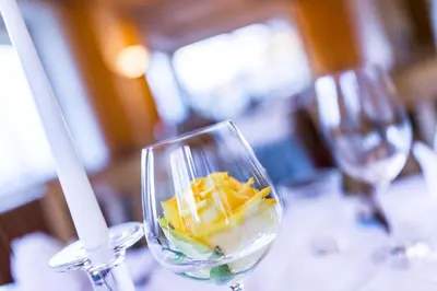 two wine glasses sitting on a table with food in them at Hotel Landgasthof Lärchenwald in Collepietra