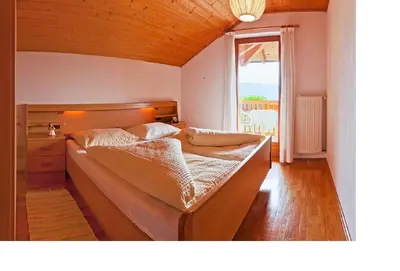 a large bed in a room with a window at Gfillhof Ferienwohnung 1 in Appiano sulla Strada del Vino
