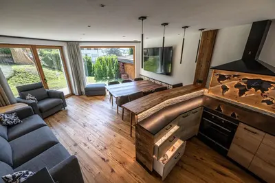 a living room with a couch and a table at Chalet Berna in Ortisei