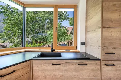 a kitchen with a sink and a window at Chalet Berna in Ortisei