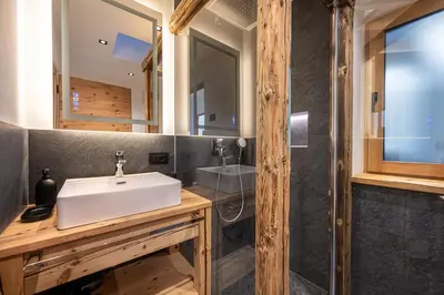 a bathroom with a sink and a shower at Chalet Berna in Ortisei