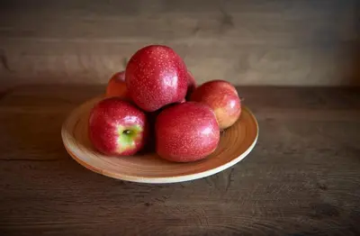 a pile of apples on a plate on a table at Hotel Gantkofel in Andrian
