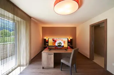 a home office with a desk and a window at Hotel Gantkofel in Andrian