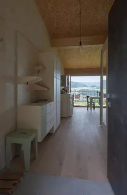 a large kitchen with white cabinets and a table at Das Baumhaus in Fiè
