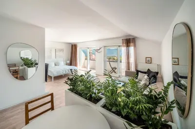 a living room with white furniture and large windows at Villa Maria Boutique Apartment St Pauls in Appiano sulla Strada del Vino