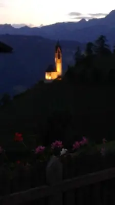 a lighthouse sitting on top of a hill at night at Agriturismo Tolpei in La Valle