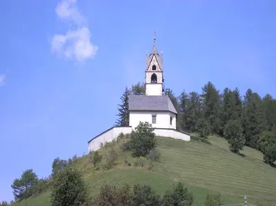 a white church on top of a hill at Agriturismo Tolpei in La Valle