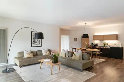 a living room with a couch and a table at Villa Hochland in Merano
