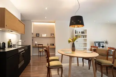 a kitchen and dining room with a table and chairs at Villa Hochland in Merano