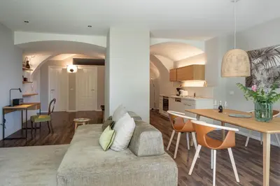 a living room and kitchen with a couch and a table at Villa Hochland in Merano