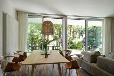 a living room with a table and chairs and a couch at Villa Hochland in Merano