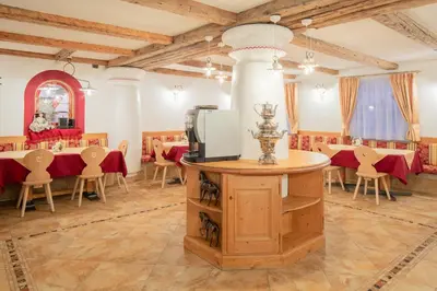 a dining room with a table with a tv on it at B&B Agriturismo Cèsa Ciasates in Canazei