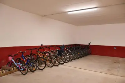 a row of bikes lined up against a wall at B&B Agriturismo Cèsa Ciasates in Canazei